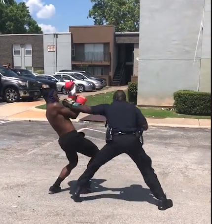 Officer Winston Bowen spars with a teenager who challenged him at a neighborhood barbecue.