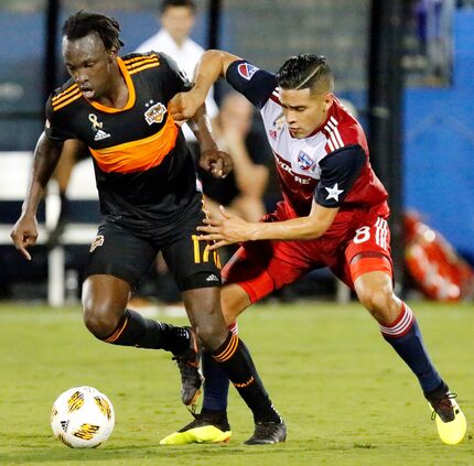 FC Dallas midfielder Victor Ulloa (8) defends Houston Dynamo forward Alberth Elis (17)...