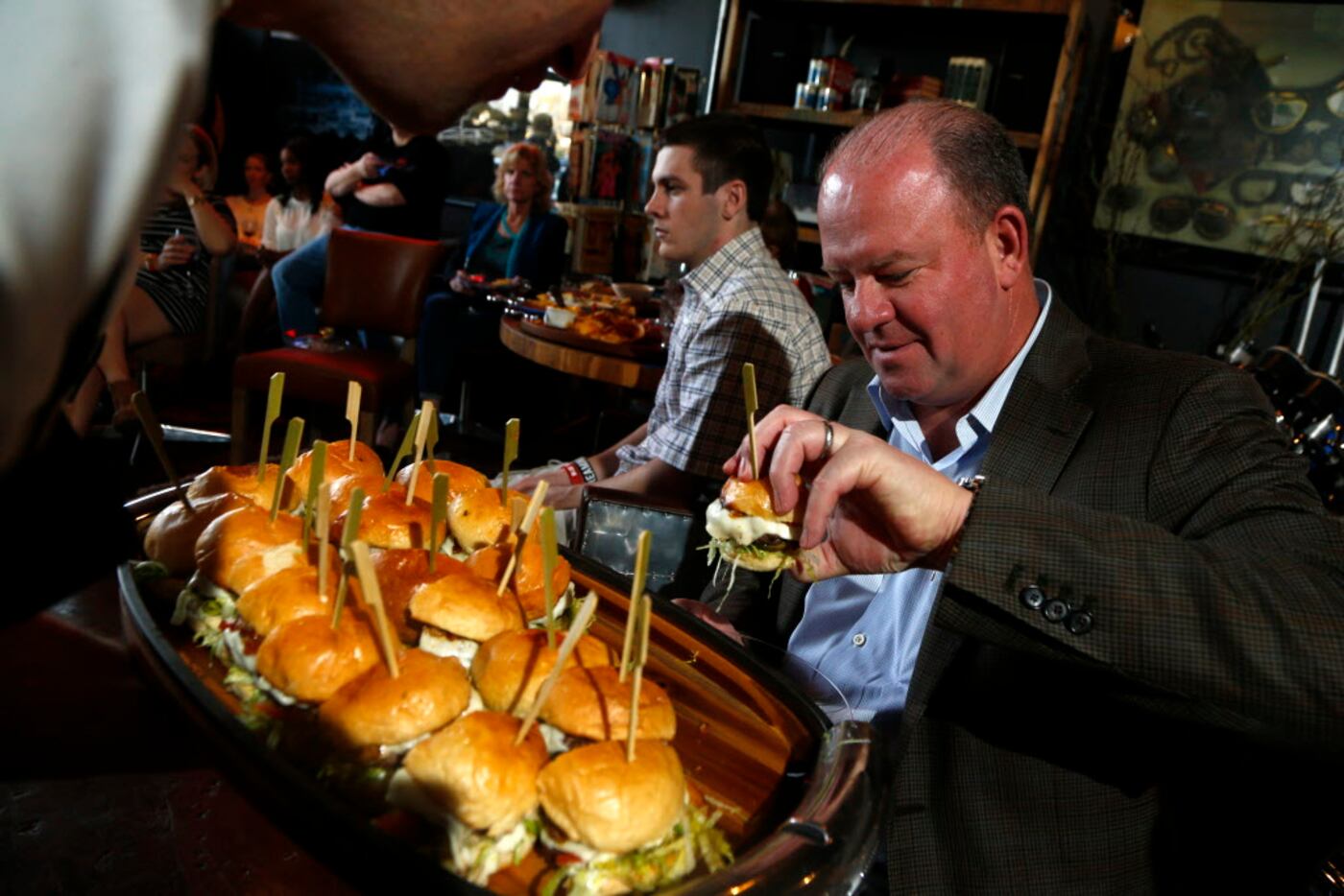 Mark McCants picks out a burger  during a class about how to create a killer burger next to...