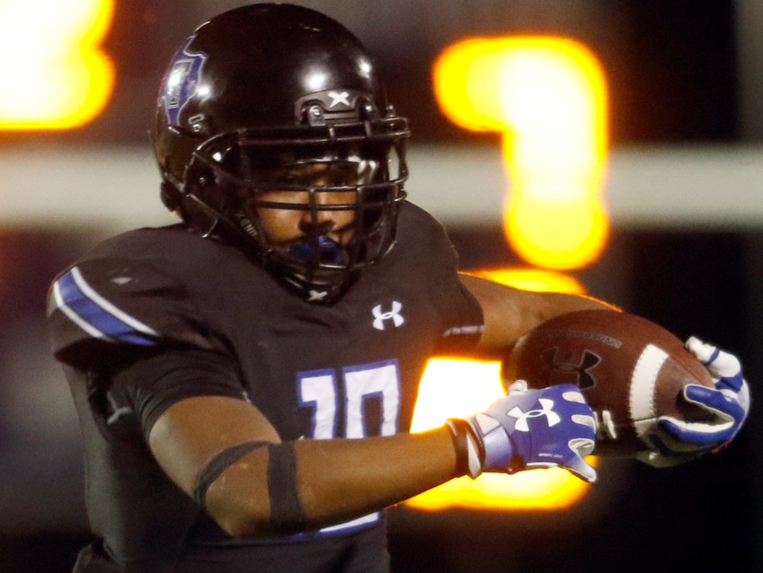 Trinity Christian running back Emari Matthews (18) rolls out of the backfield as he follows...