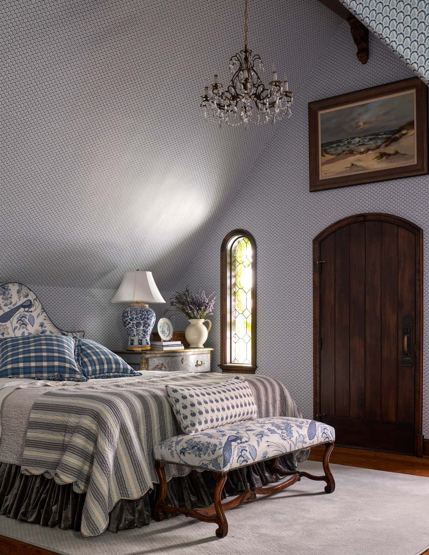 Bedroom interior in a blue motif with vaulted ceilings