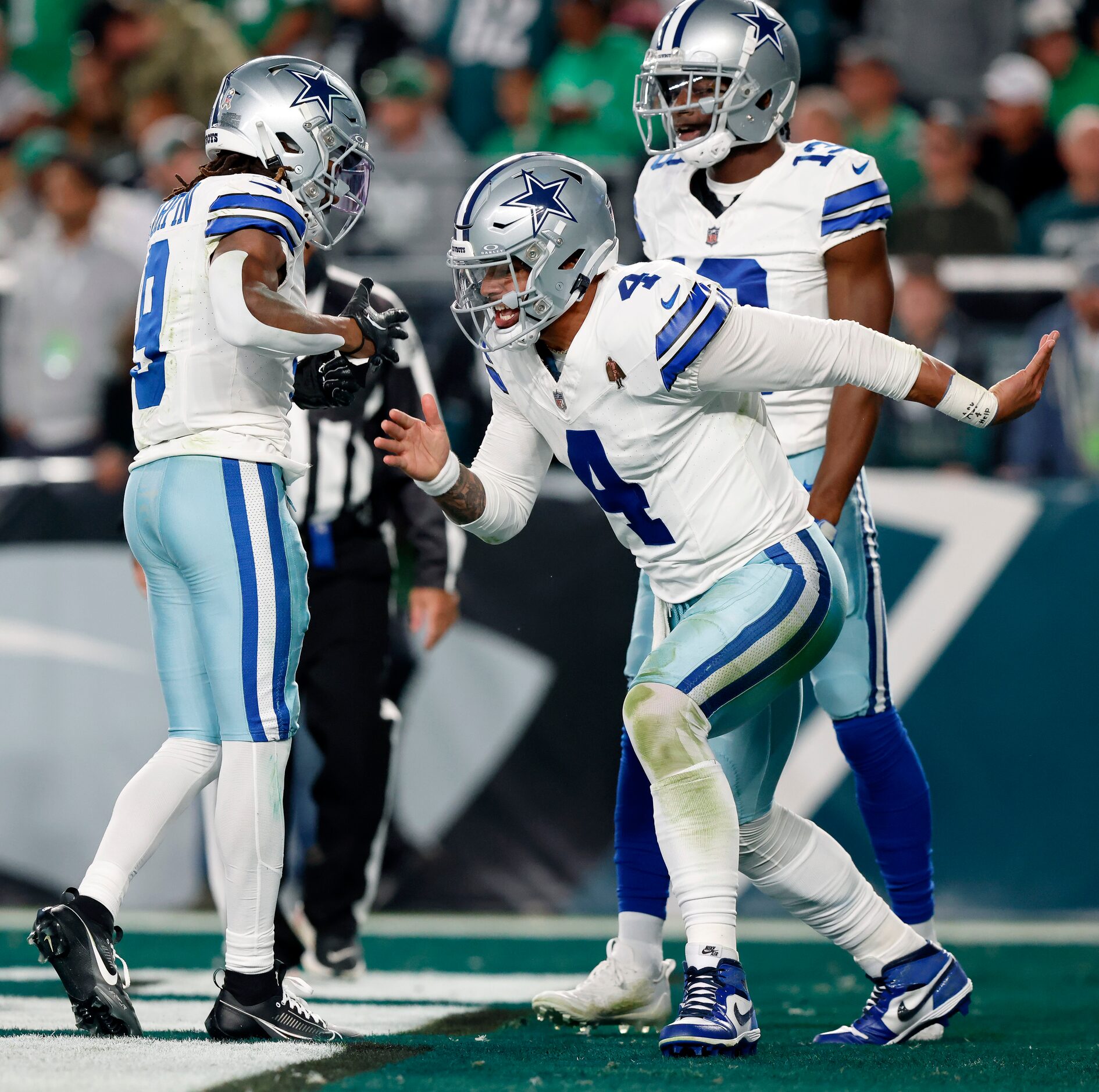 Dallas Cowboys quarterback Dak Prescott (4) slapped and hands with wide receiver KaVontae...