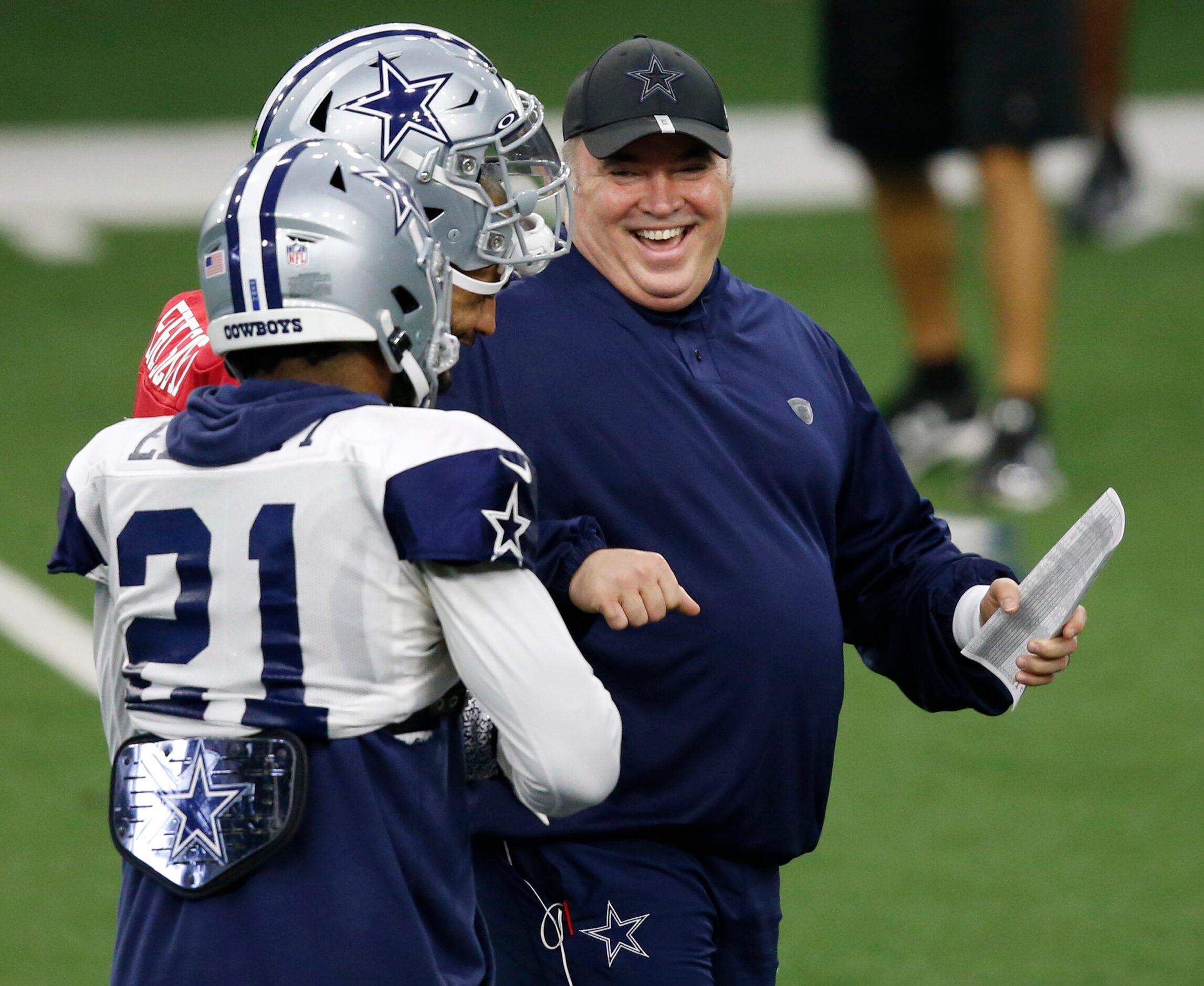 Dallas Cowboys head coach Mike McCarthy laughs as he talks with Dallas Cowboys quarterback...