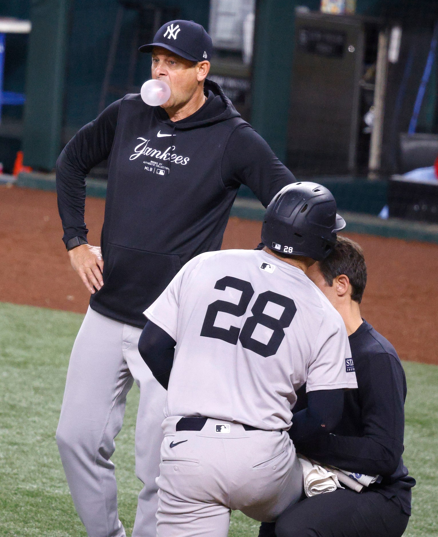 New York Yankees manager Aaron Boone blows a bubble gum as New York Yankees catcher Austin...