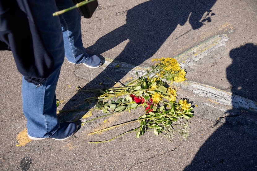 Flowers on the ’X’ marking the site where 61 years ago President John F. Kennedy was...