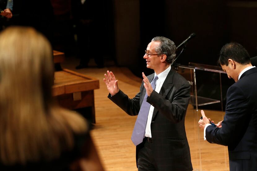 Fabio Luisi, the new music director for the Dallas Symphony Orchestra, waves before leaving...