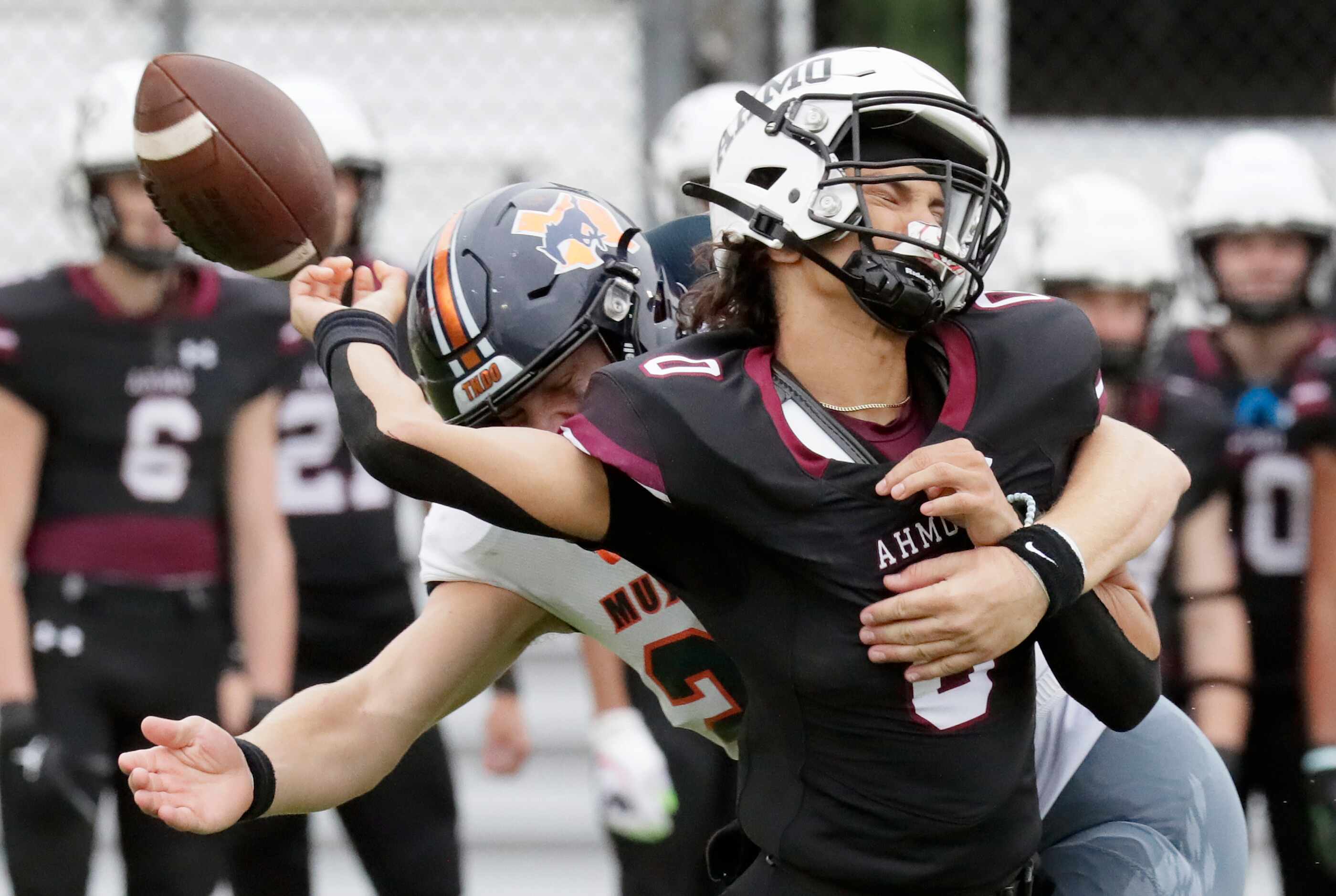 Wylie High School quarterback Jagger Bale (0) is hit by Sachse High School middle linebacker...