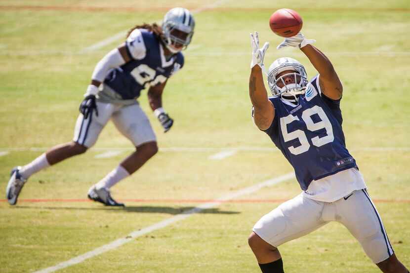 Dallas Cowboys outside linebacker Anthony Hitchens (59) reaches for a pass during morning...