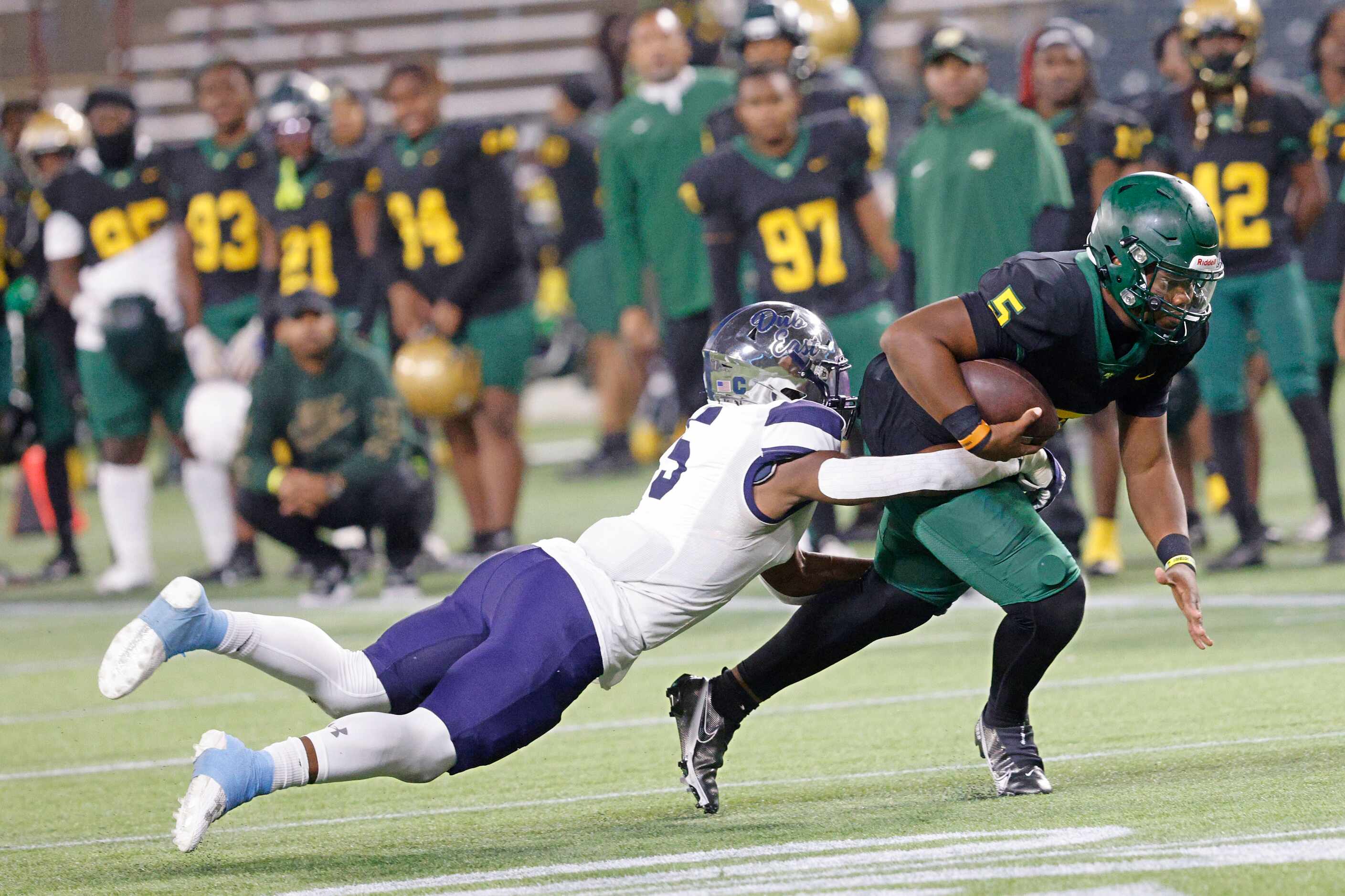DeSoto's quarterback Darius Bailey (5) is tackled by Wylie East's Rome Jeffers (5) during...