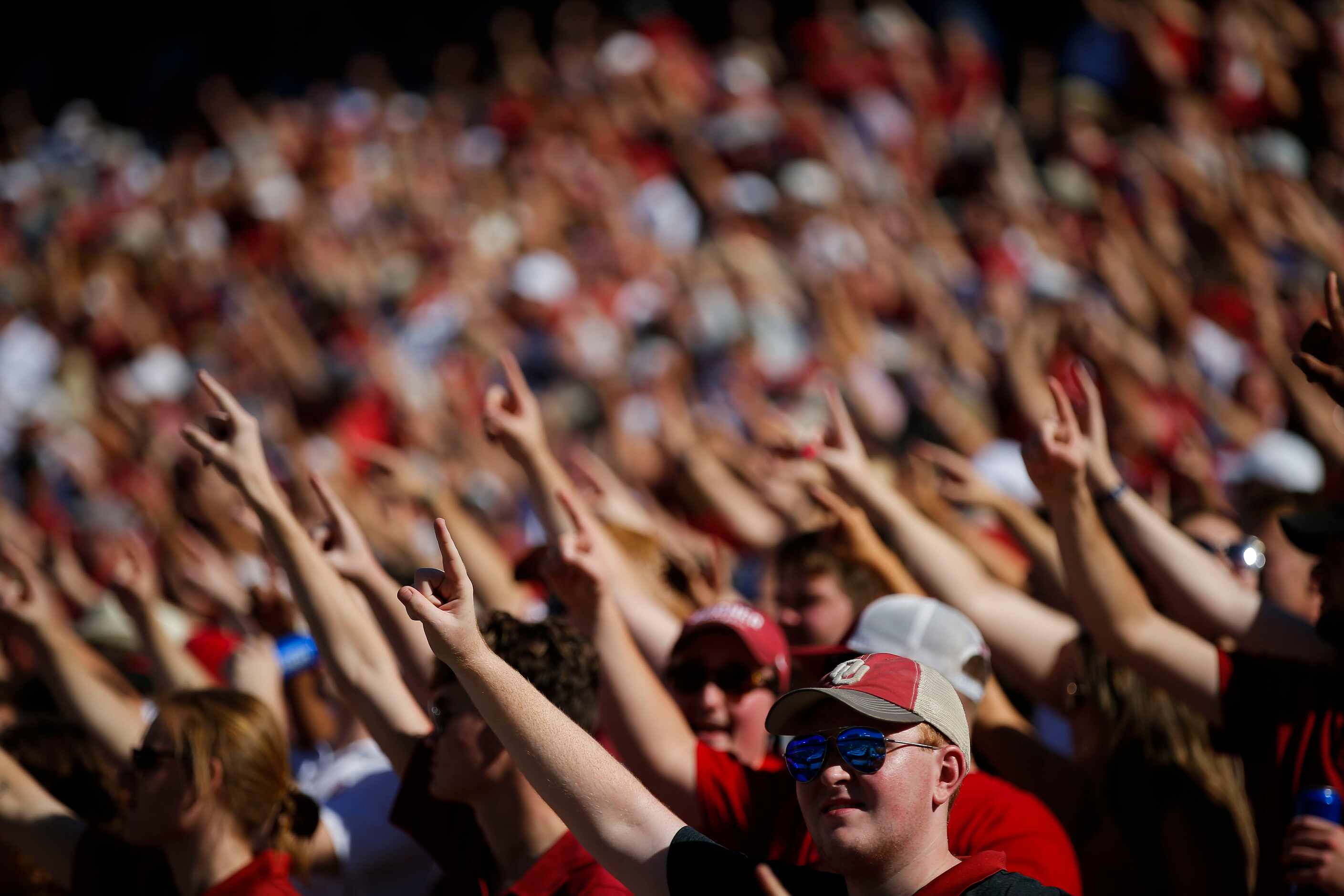 Oklahoma fans cheer for their team during the first half of an NCAA college football game...