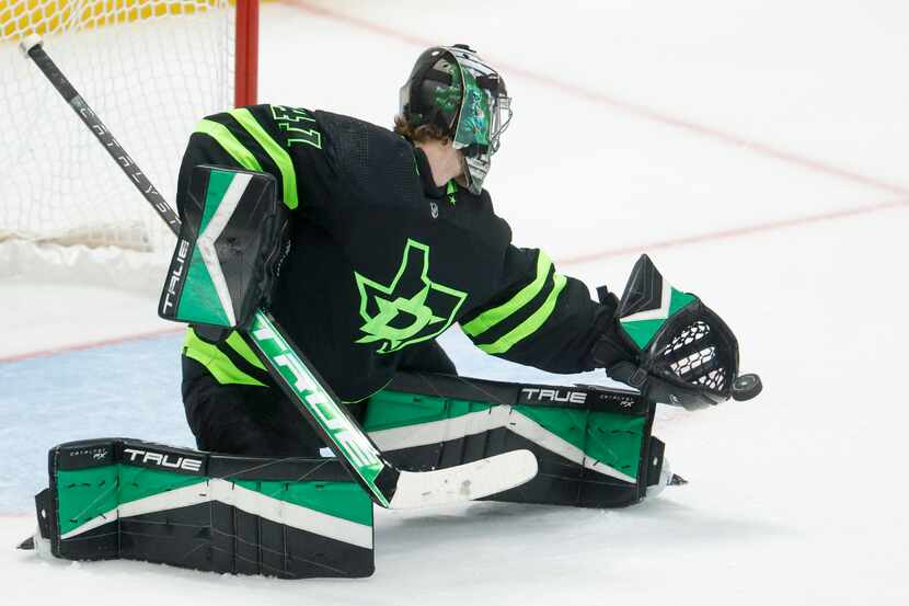 Dallas Stars goaltender Scott Wedgewood (41) reaches to make a stop with his glove during...
