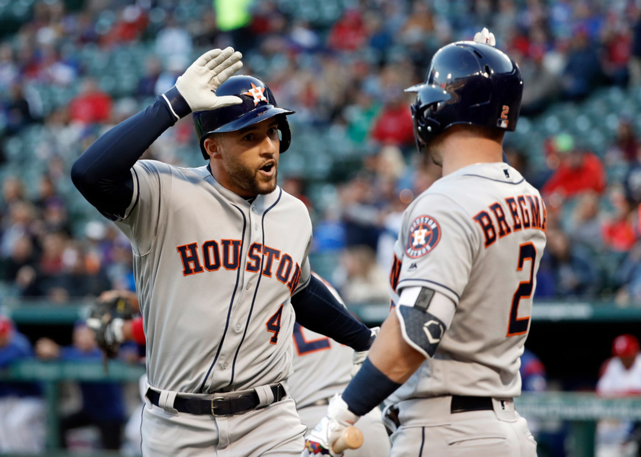 Houston Astros' George Springer (4) celebrates his lead-off home run with Alex Bregman (2)...