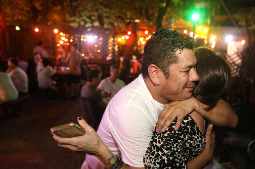 David Olarte, left, and Molly Tracy hug as they enjoy one last evening at the Grapevine Bar...