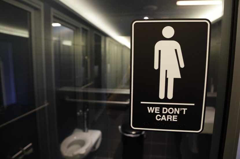FILE - This Thursday, May 12, 2016, file photo, shows signage outside a restroom at 21c...