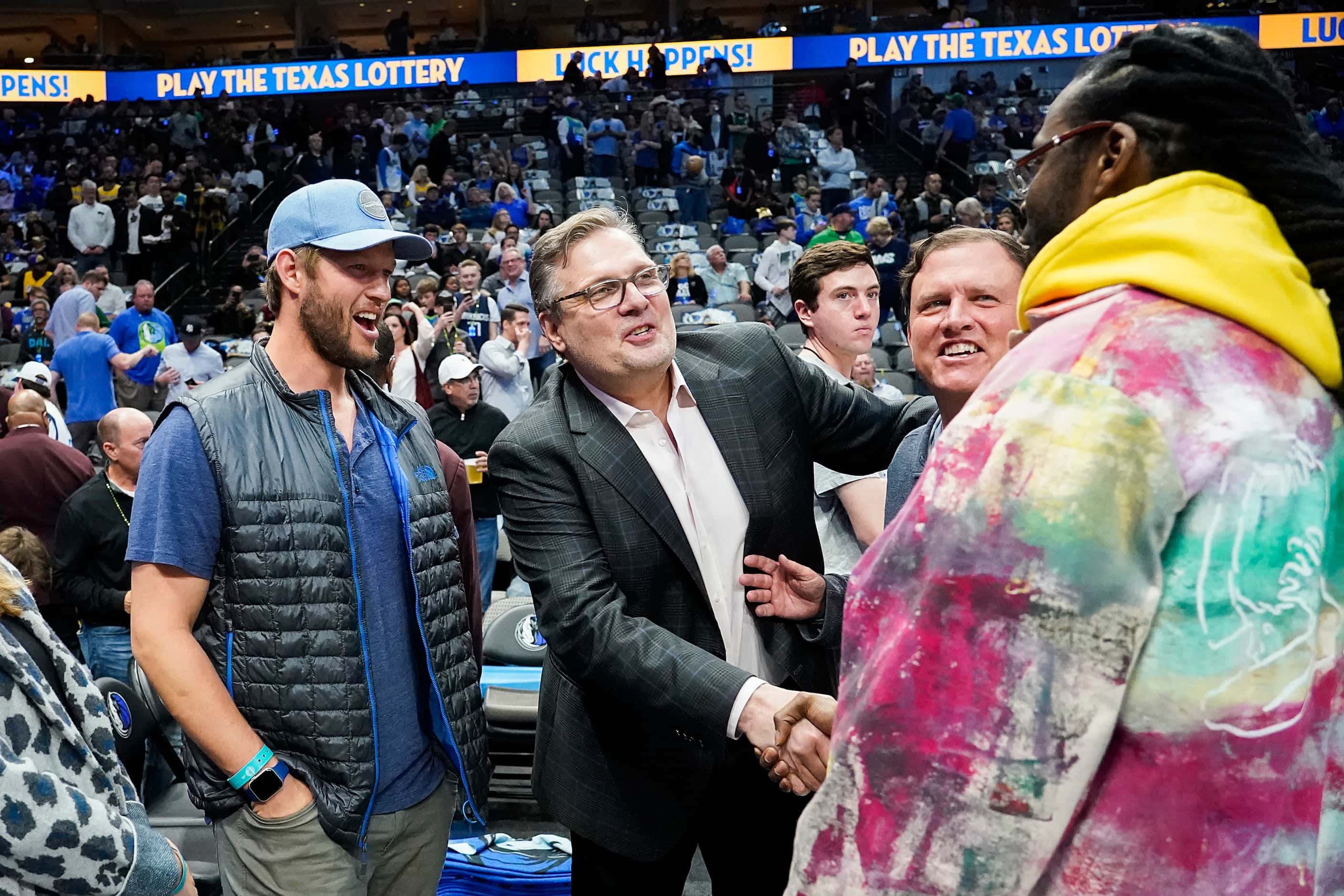 Dallas Mavericks general manager Donnie Nelson shakes hands with rapper 2 Chainz as Los...