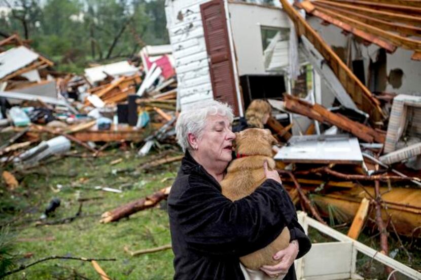 
Constance Lambert clutched her dog Monday, thankful it was alive after she returned to her...
