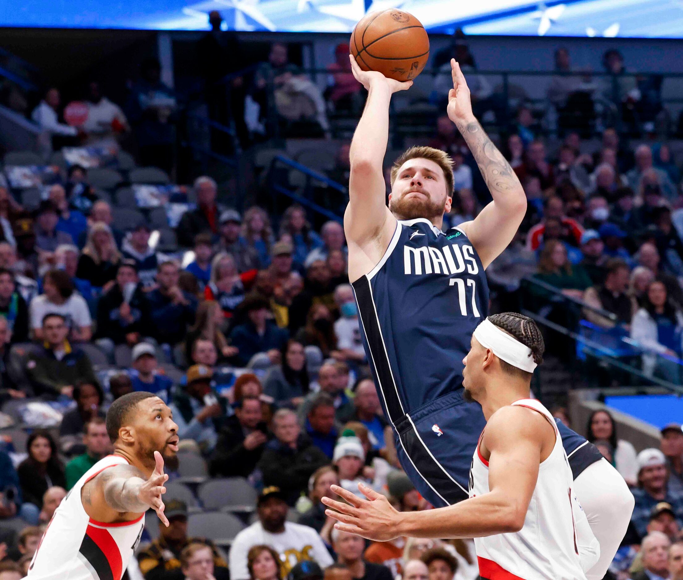 Dallas Mavericks guard Luka Doncic (77) shoots as Portland Trail Blazers guard Damian...