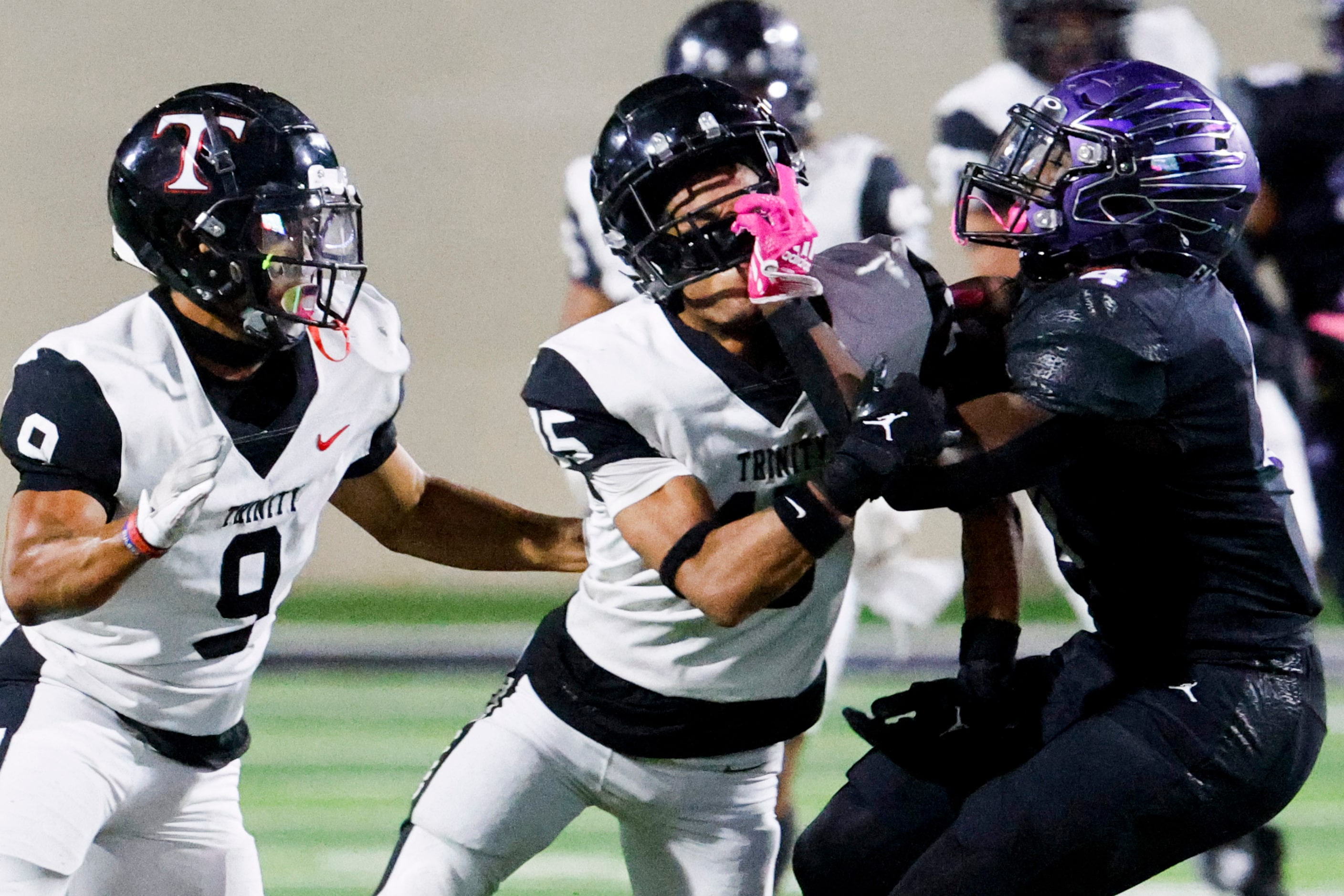 Trinity High’s Monte Easley (left) watches as Kaden Donaldson (center) is tackled by Crowley...