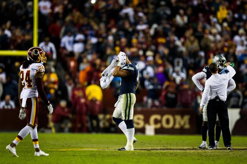 Dallas Cowboys quarterback Dak Prescott (4) wipes his head with a towel during a timeout in...
