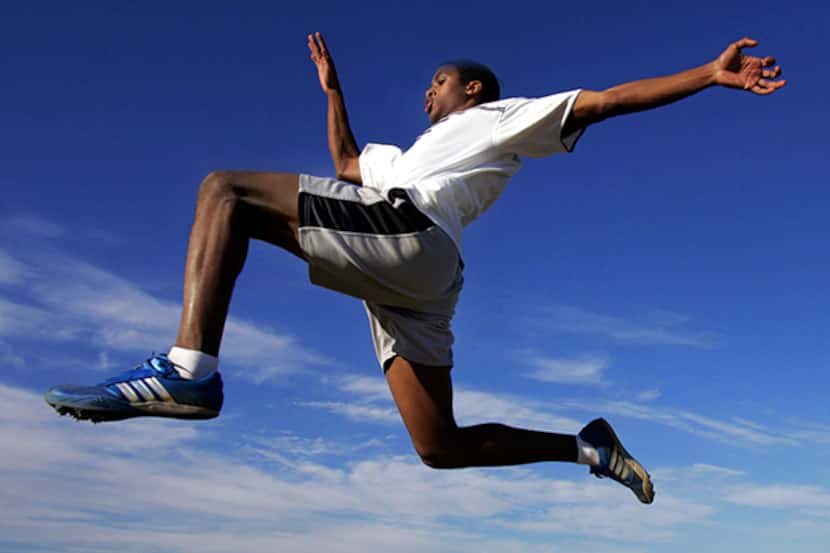  March 8,Â 2005--Grapevine High School long jumper Victor Dupuy flies through the air during...