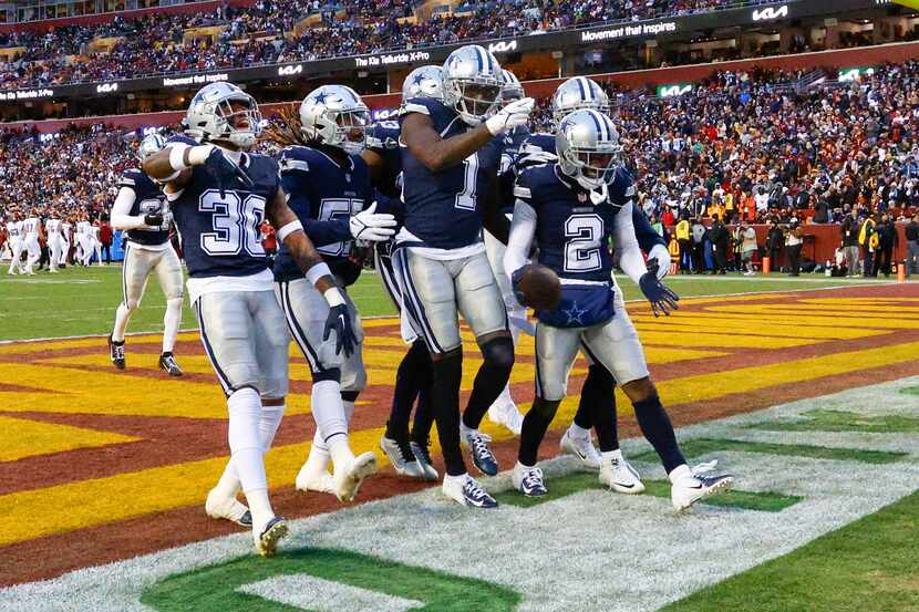 The Dallas Cowboys defense celebrates a fumble recovery during the first half of an NFL...