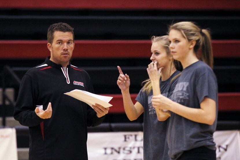 Volleyball coach Ryan Mitchell (left) coaches during a Lovejoy practice in 2013. (Kye R....
