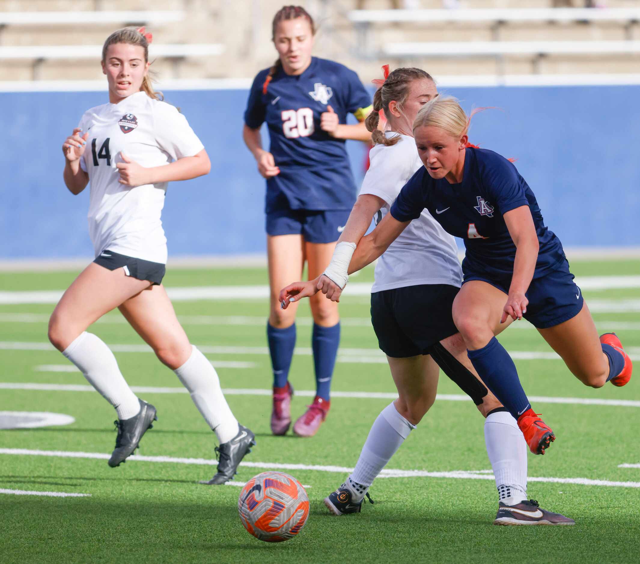 Allen’s Alexa Barker (right) dribbles past Marcus’ Allie Williams during the first half of a...