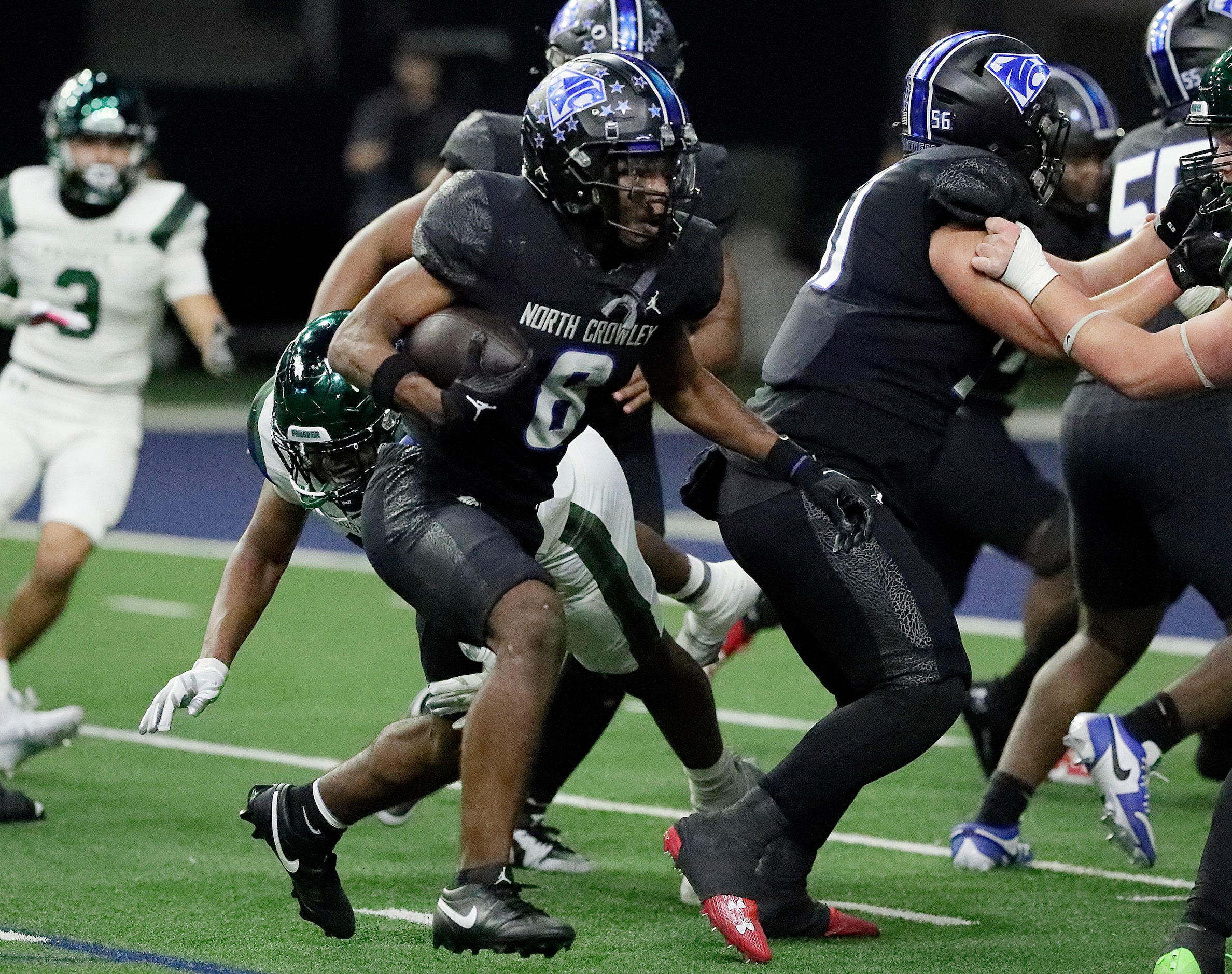 North Crowley High School running back Ashton Searl (8) looks for room to run near the goal...