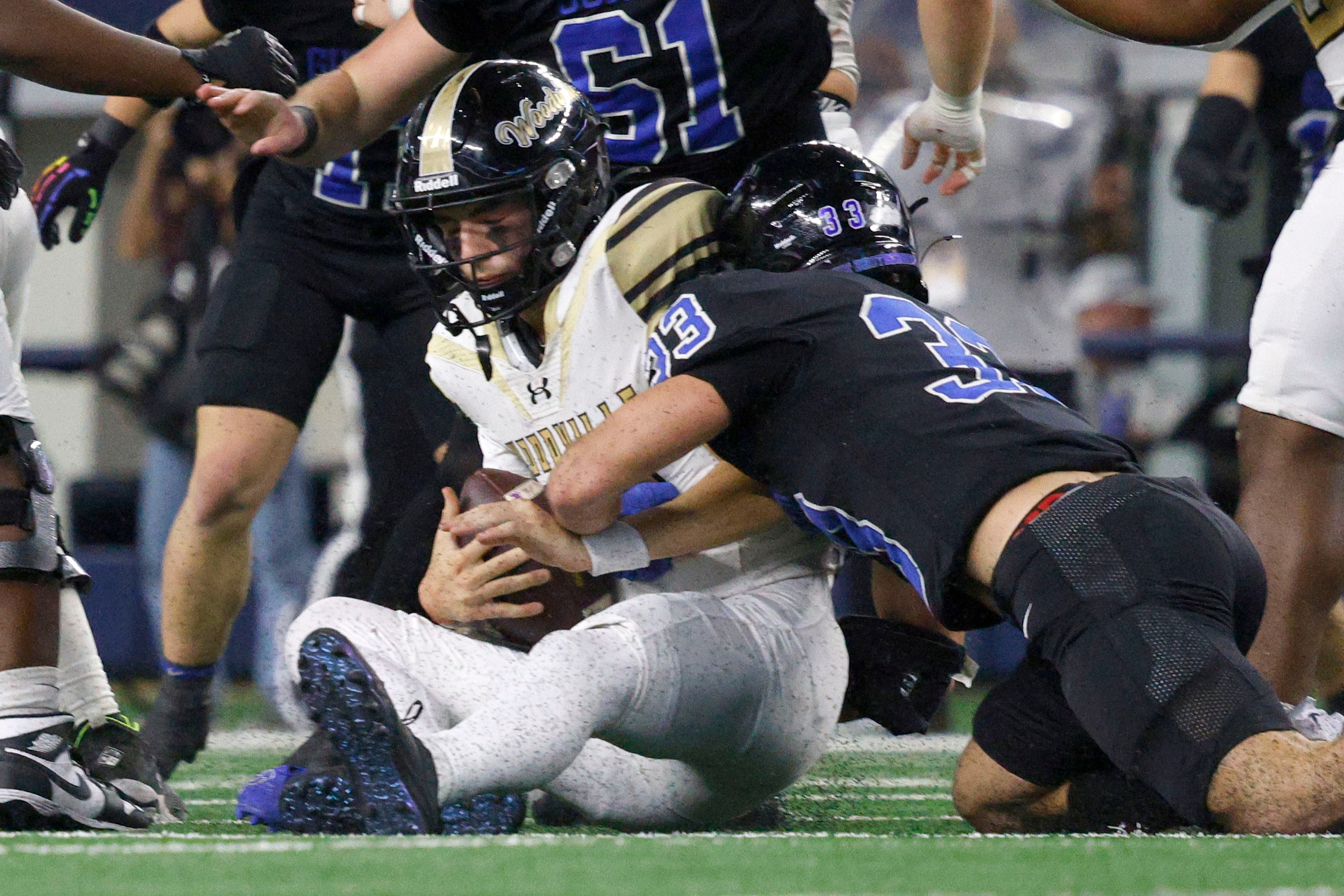 Woodville's quarterback Luke Babin (13) is sacked by Gunter's  Hayden Farrell (33) in the...