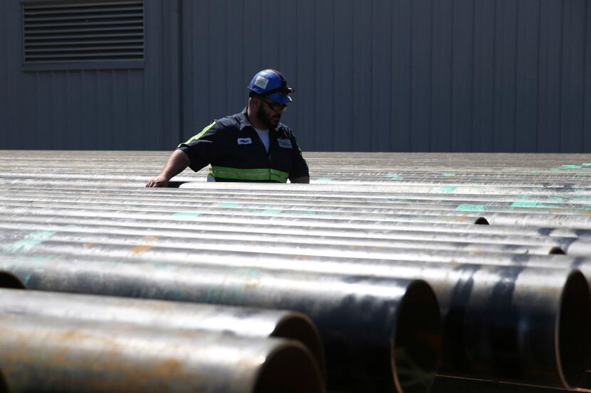 William Hampton walks between steel pipes at the Borusan Mannesmann plant in Baytown.