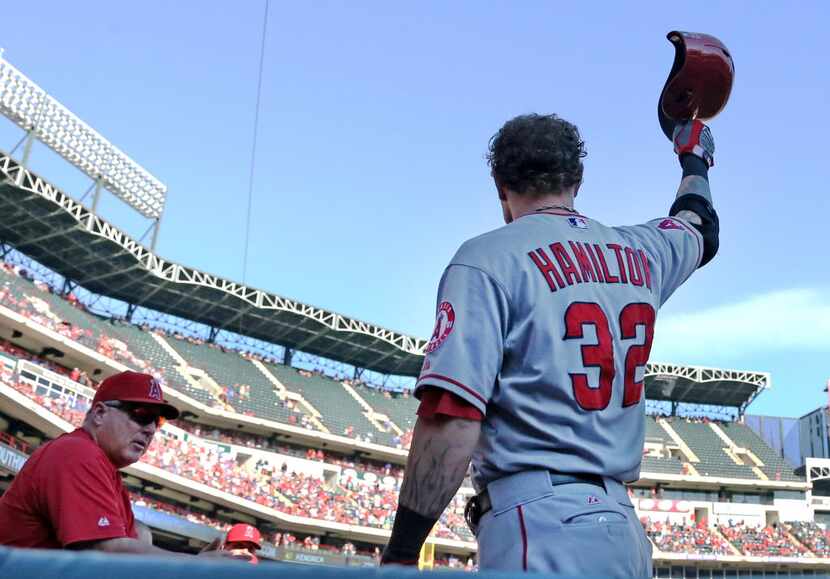 Former Rangers outfielder Josh Hamilton tips his hat to the fans as they boo him as he...