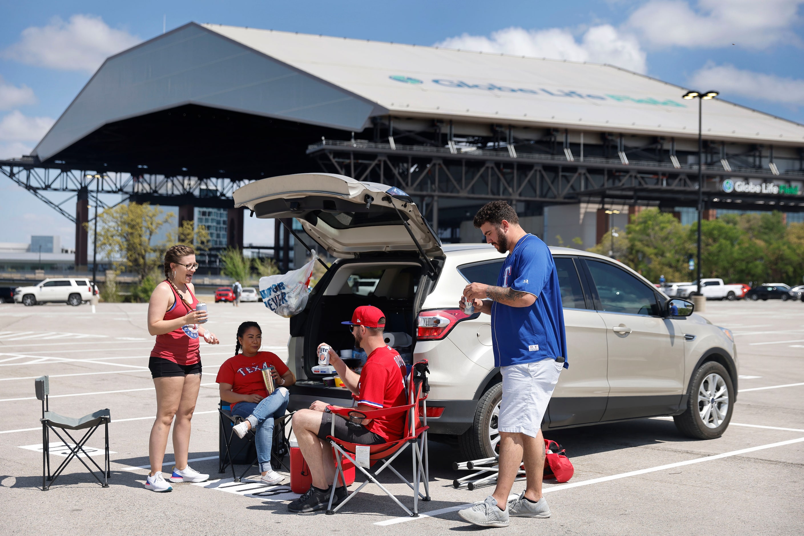 Texas Rangers fans enjoy an Opening Day tailgate party on private property outside of Globe...