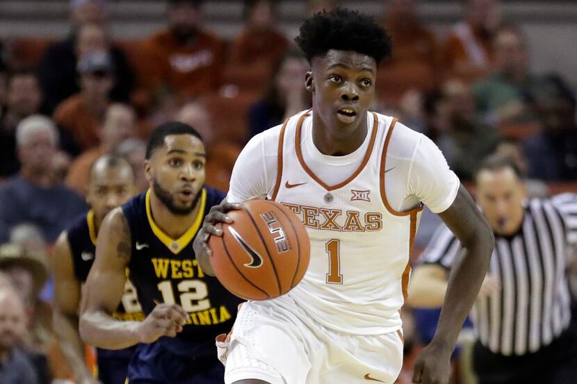 FILE - In this Jan. 14, 2017, file photo, Texas guard Andrew Jones (1) brings the ball up...