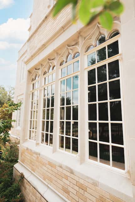 A set of four windows in a historic property have a detailed design.
