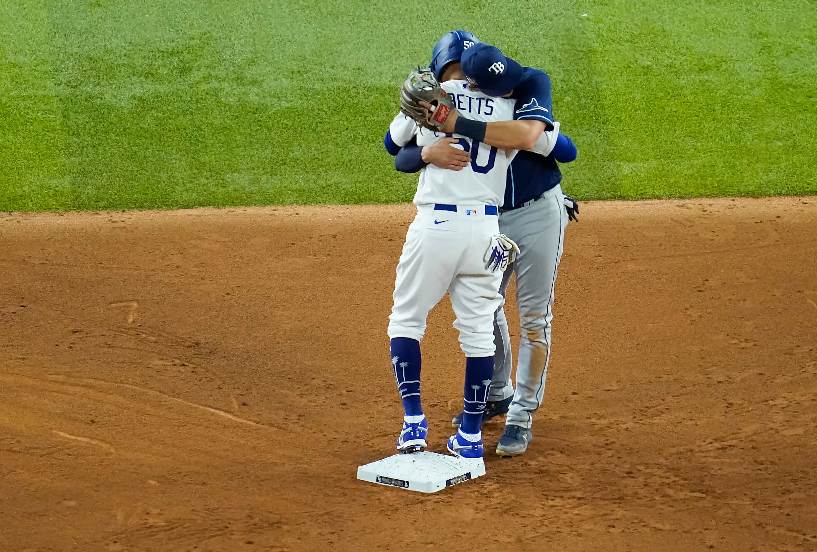 Los Angeles Dodgers right fielder Mookie Betts gets a hug from Tampa Bay Rays shortstop...