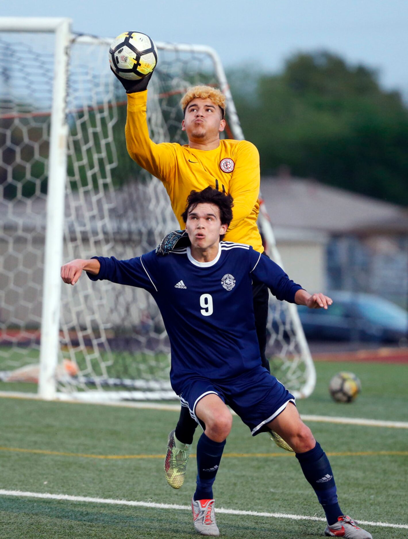 W.T. White goalie Bryan Espinoza (00) bats the ball away from Flower Mound's Niko Zeppenfeld...