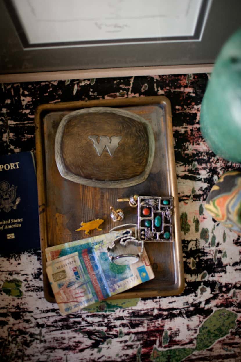 A vintage belt buckle and collectibles on Baker's bedside table