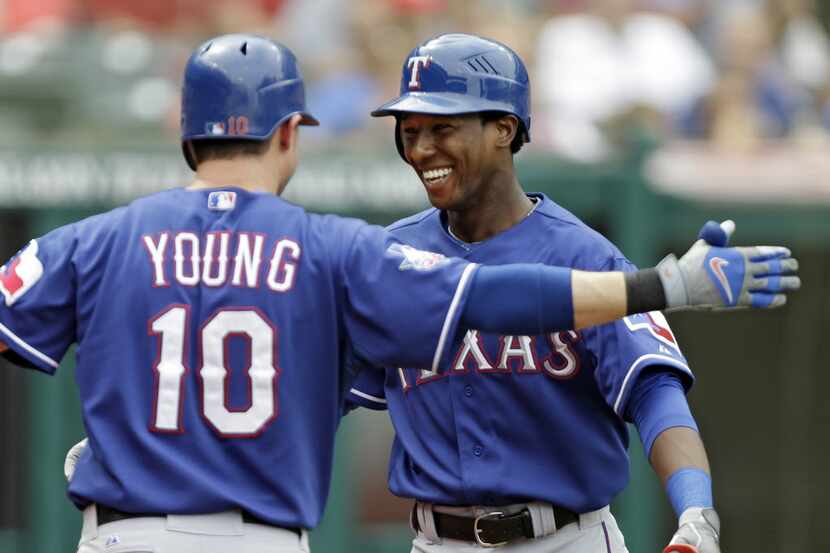 Texas Rangers' Jurickson Profar, right, is greeted by Michael Young (10) after a solo home...
