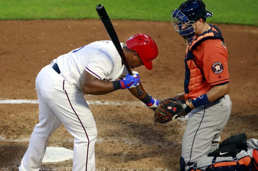 Texas Rangers third baseman Adrian Beltre (29) hands a pitch in the dirt to Houston Astros...