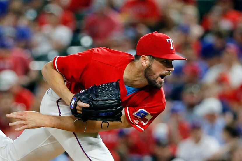 Texas Rangers starting pitcher Cole Hamels follows through on his delivery to the Detroit...