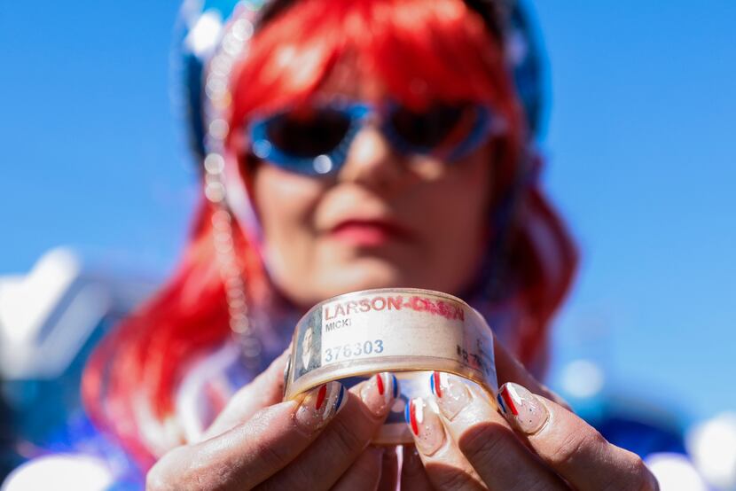 Micki Larson-Olson shows off her prison wristband that she received during her sentence for...