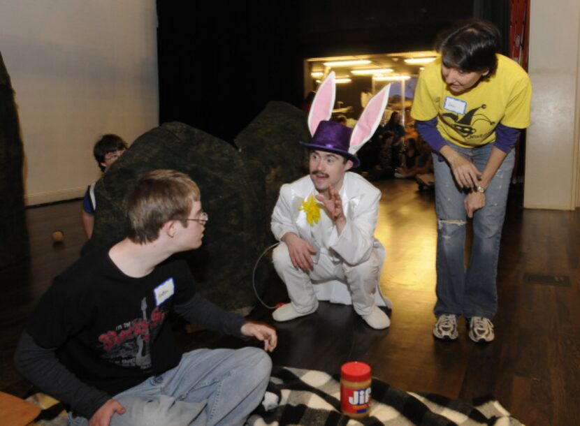 Director Lisa Schmidt, right, helps Matthew Kwasniak, left, and Austin Davenport, center,...