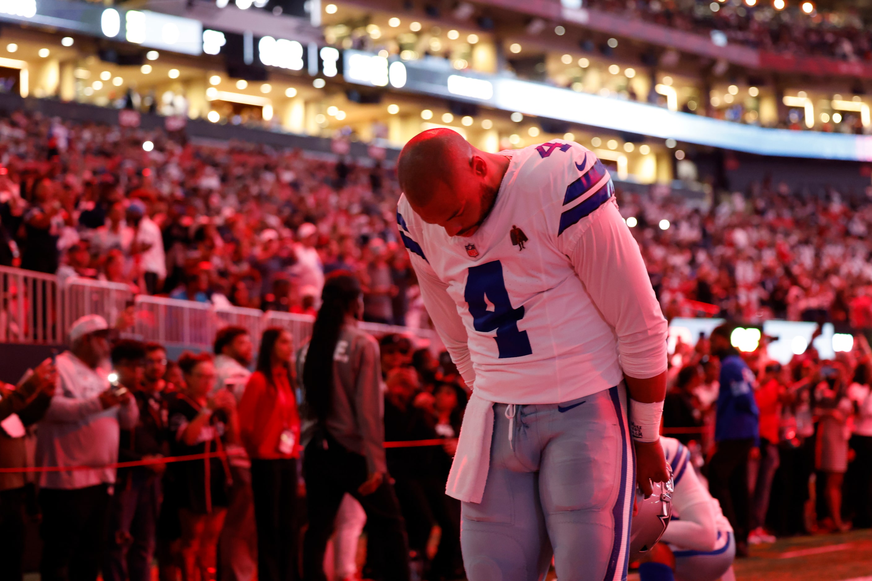 Dallas Cowboys quarterback Dak Prescott (4) bows his head before a game against the Atlanta...