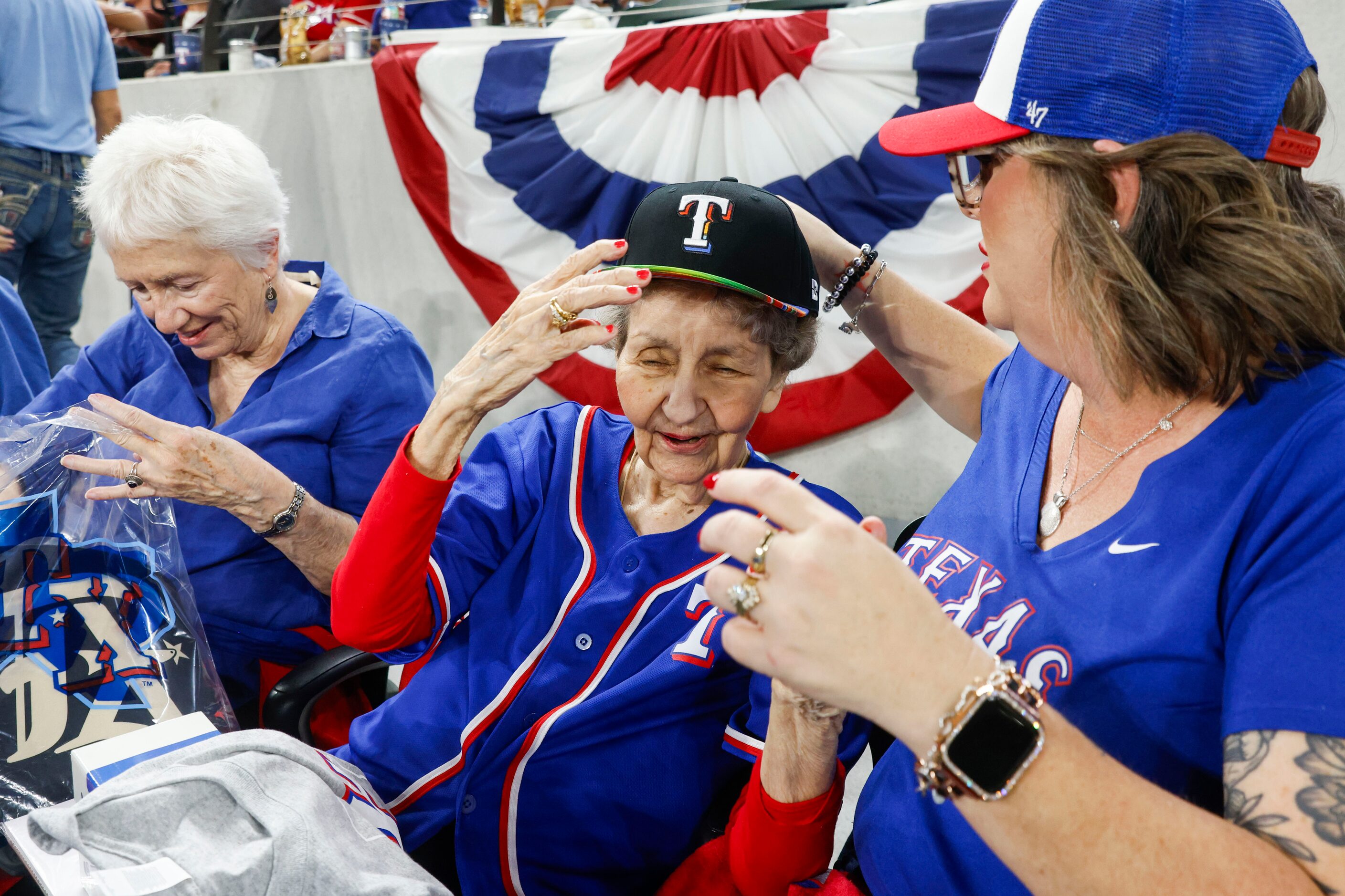 Texas Rangers fan Dorothy Jones. 93. (middle) reacts as director of nursing at Teresa’s...