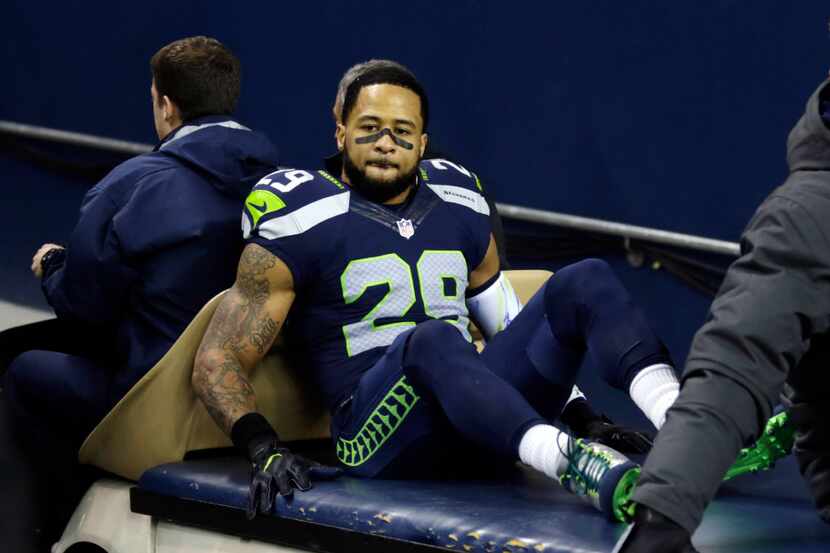 Seattle Seahawks' Earl Thomas leaves the field on a cart after being injured against the...