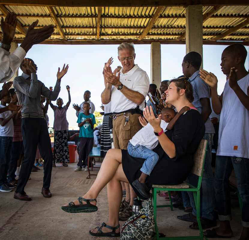 Jacklyn Vanderpool holds a child in her lap as she worships with her father, Dr. David...