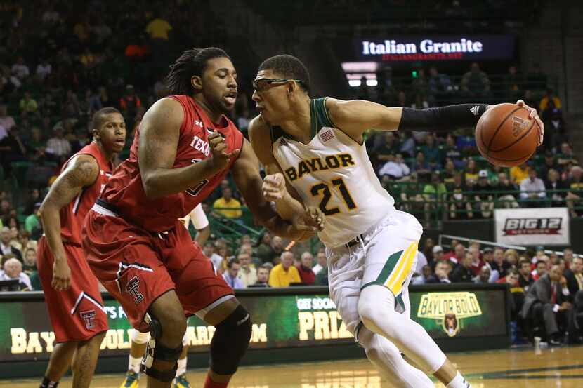 Baylor center Isaiah Austin (21) is pressured by Texas Tech Aaron Ross (15) during in the...