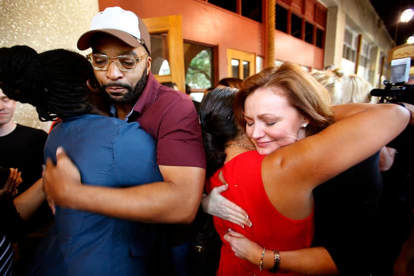 Kidd Kraddick's co-hosts Kellie Rasberry (right) and Big Al Mack hugged grieving fans...