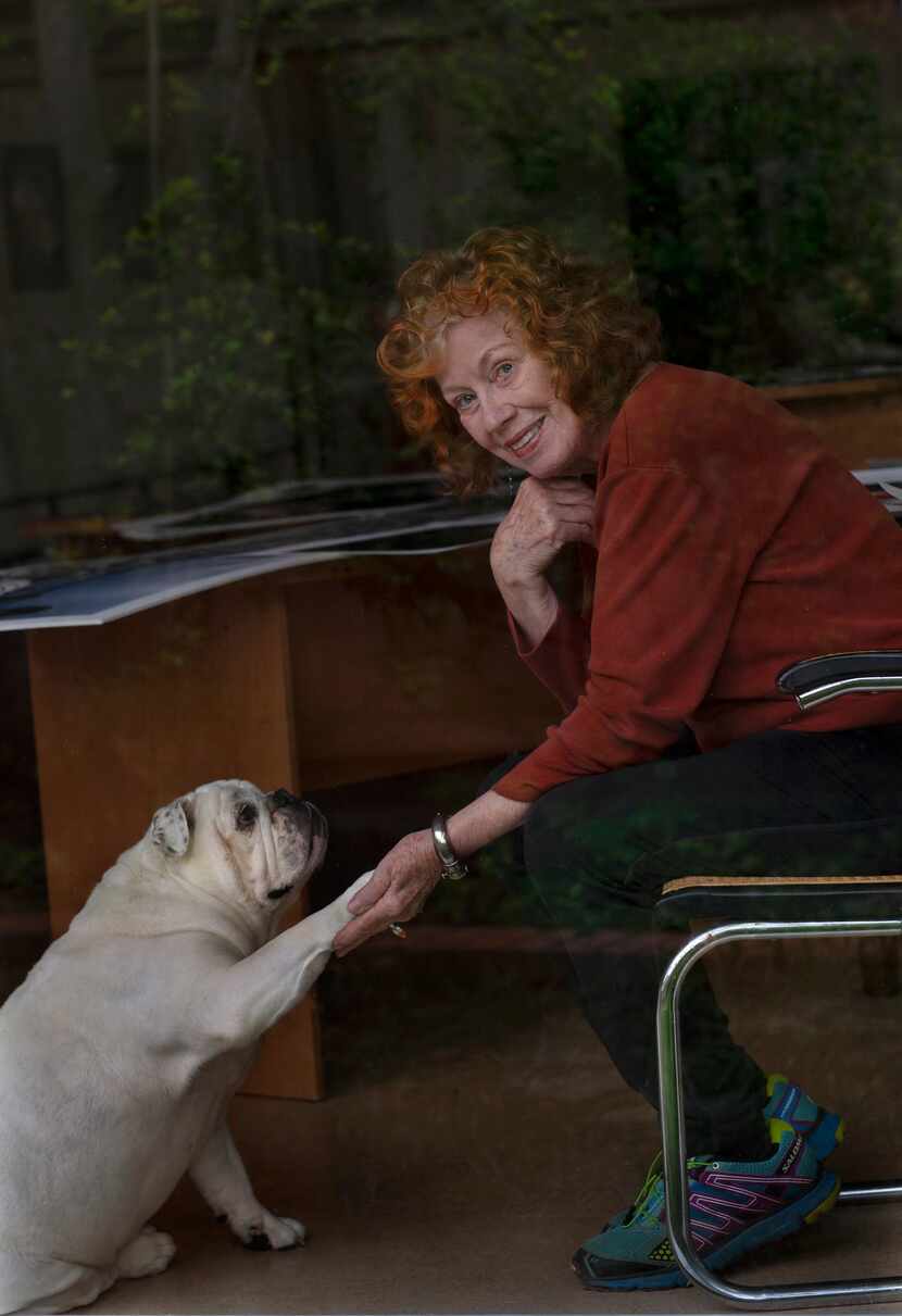Photographer Carolyn Brown and her English bulldog Ellie Mae, photographed behind glass, are...