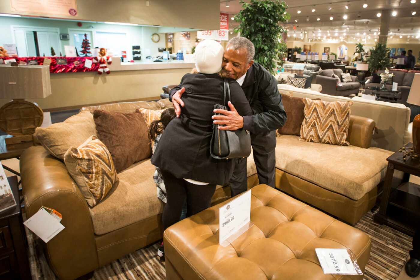 Williams Chicken CEO and founder Hiawatha Williams hugged Bridget Galvan as she shopped for...